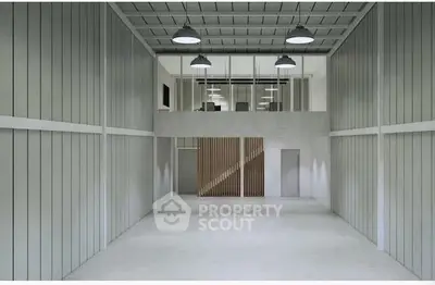 Spacious industrial warehouse with high ceilings and modern lighting.