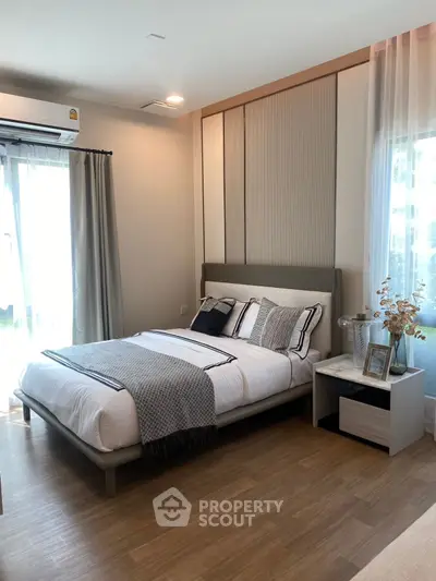 Modern bedroom with stylish decor and natural light