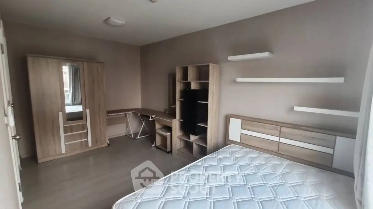 Modern bedroom with sleek furniture and ample natural light, perfect for a cozy living space.