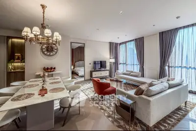 Luxurious open-plan living and dining area with elegant decor and city views.