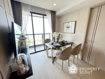 Elegantly furnished apartment with a spacious dining area, modern decor, and abundant natural light streaming through large balcony doors, offering a serene urban retreat.