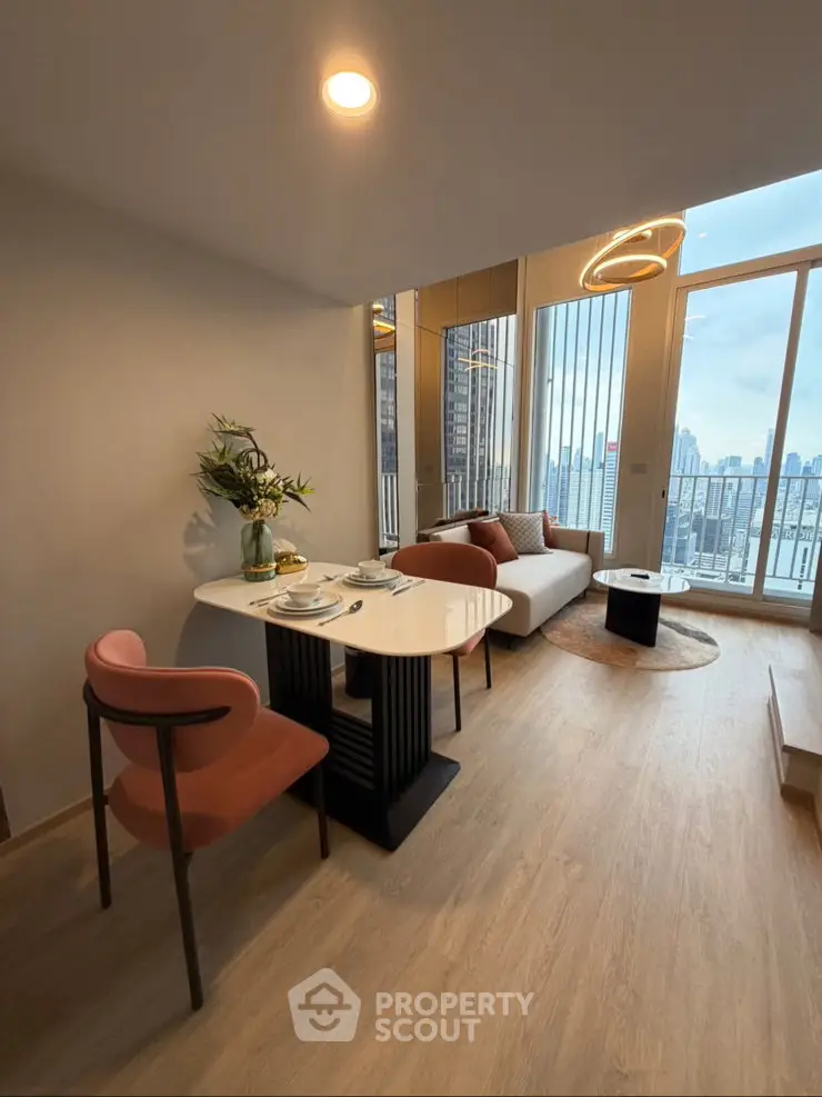Modern living room with city view, stylish furniture, and elegant lighting in a high-rise apartment.