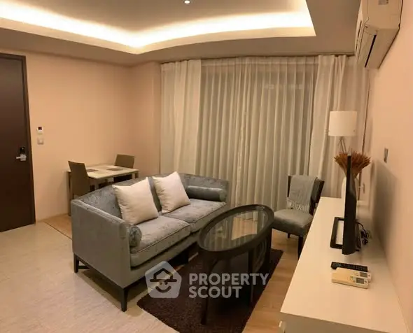 Modern living room with stylish furniture and ambient lighting, perfect for cozy evenings.