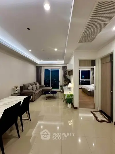 Spacious modern living room with elegant dining area and cozy bedroom view.