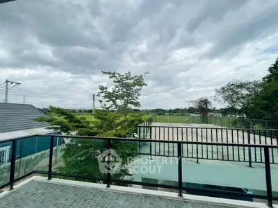 Spacious balcony with scenic view of lush greenery and open sky