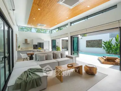 Luxurious open-plan living room with pool view and modern decor