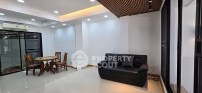 Spacious modern living room with sleek design and cozy seating area.