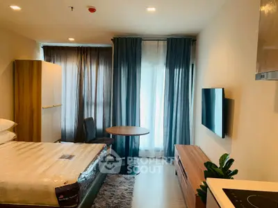 Modern studio apartment with cozy bed, dining table, and wall-mounted TV, featuring elegant curtains and natural light.