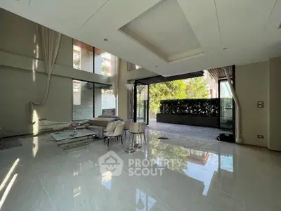 Luxurious open living room with high ceilings and garden view