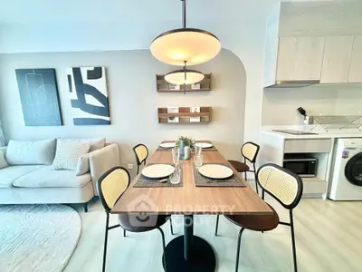 Modern dining area with stylish lighting and cozy living room setup