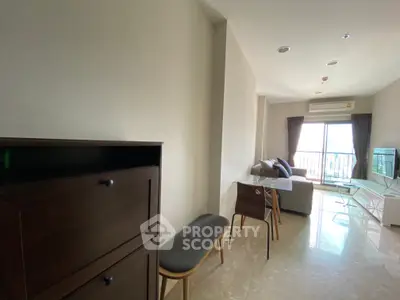 Modern living room with sleek furniture and natural light from balcony