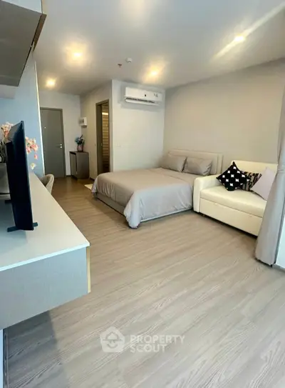 Modern studio apartment with cozy bed and stylish decor