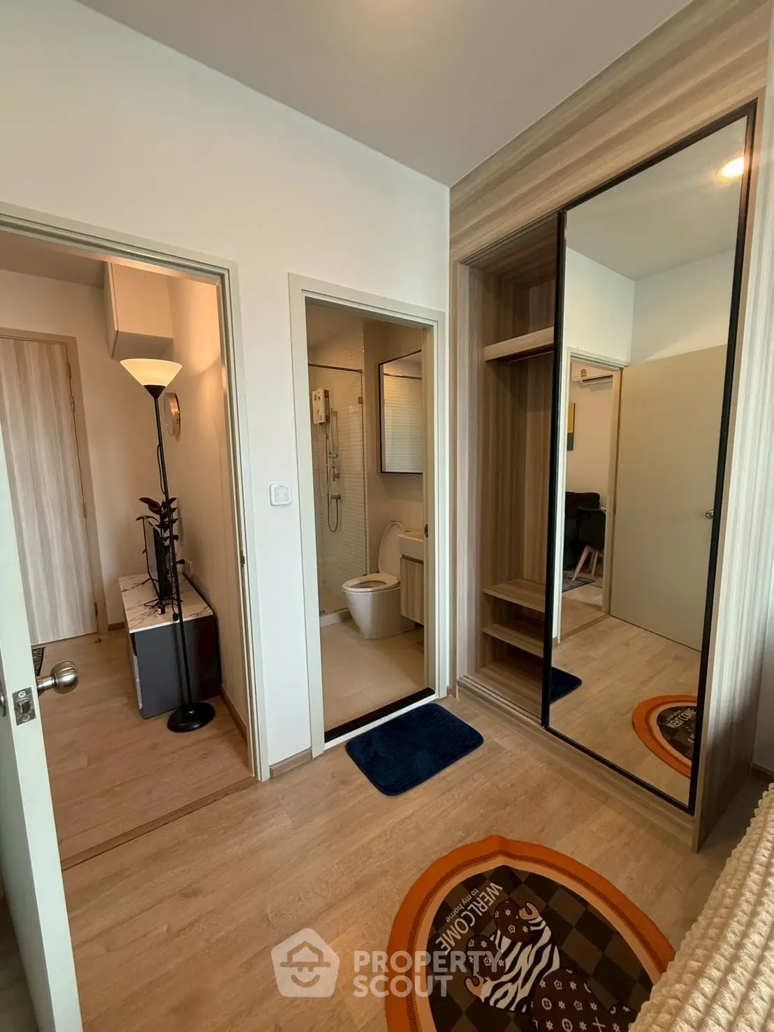 Modern bedroom with ensuite bathroom and mirrored wardrobe