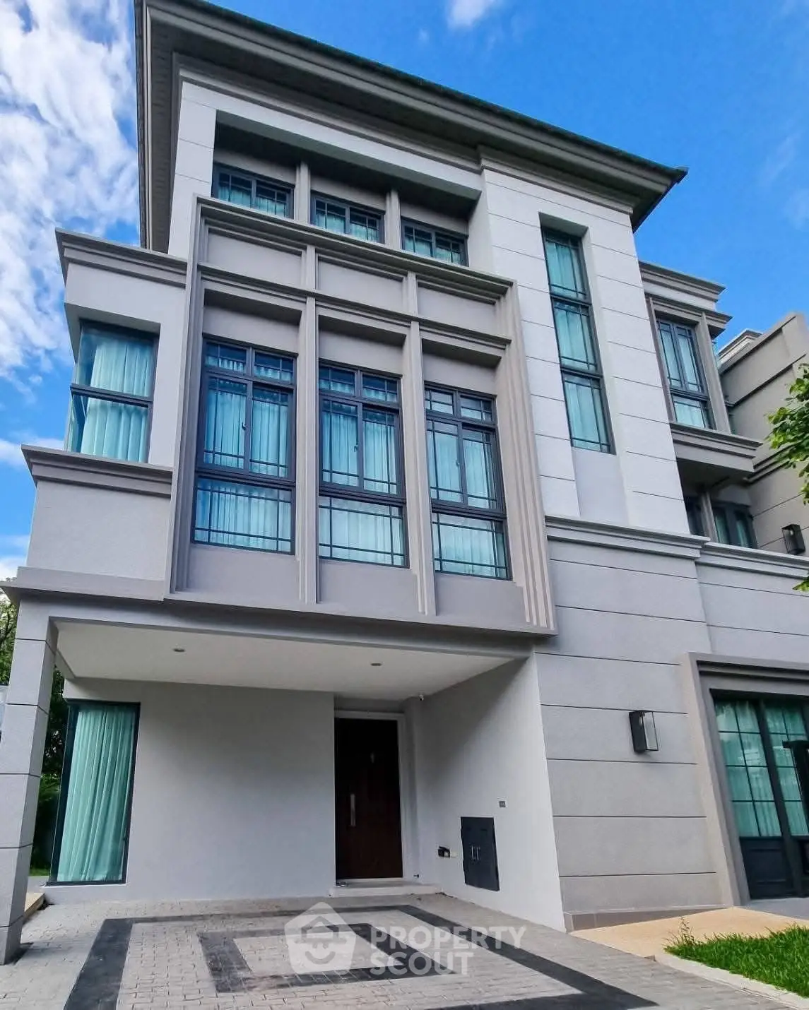 Modern multi-story building with sleek design and large windows