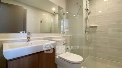 Modern bathroom with sleek fixtures and glass shower enclosure