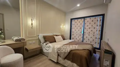 Cozy bedroom with elegant decor and soft lighting, featuring a comfortable bed and stylish furnishings.