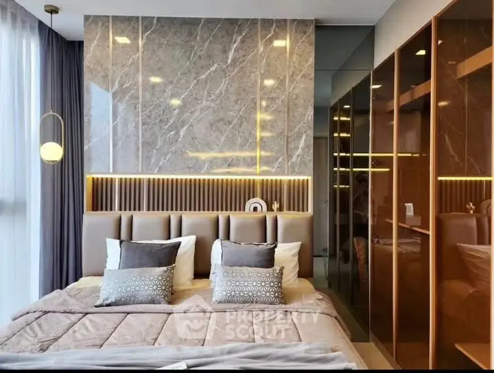 Luxurious modern bedroom with elegant design and stylish lighting, featuring a plush bed and mirrored wardrobe.