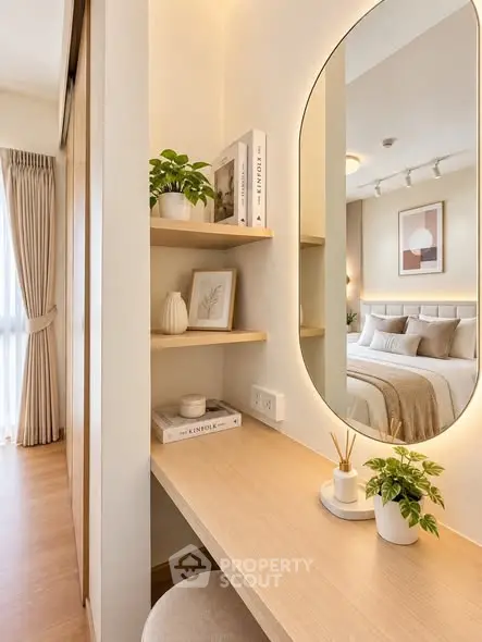 Elegant bedroom with stylish decor and cozy workspace, featuring natural light and modern furnishings.