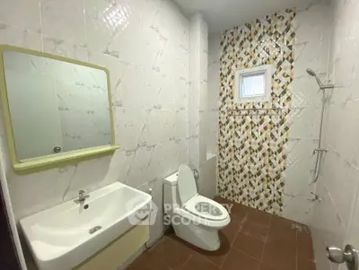 Modern bathroom with stylish tile design and compact layout