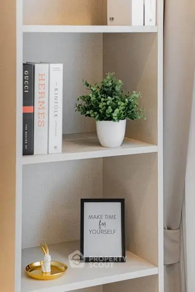 Stylish bookshelf with decor items in modern living room interior.