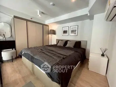 Modern bedroom with stylish decor and ample storage in a contemporary apartment.