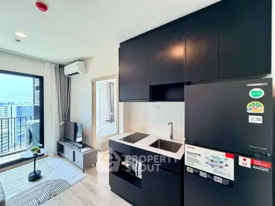 Modern apartment with sleek kitchen and cozy living area, featuring city views and contemporary design.