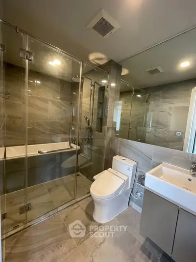Luxurious modern bathroom with glass shower and sleek fixtures