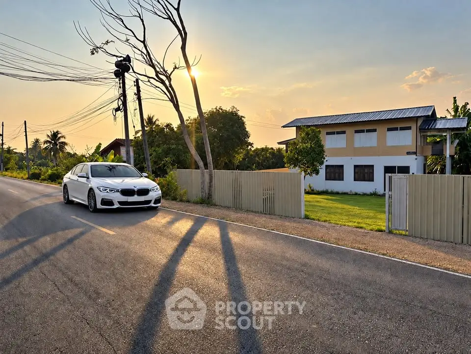 Charming suburban house with lush garden and scenic sunset view, perfect for tranquil living.
