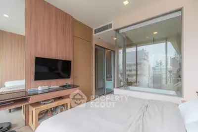 Modern bedroom with city view, featuring a glass wall and sleek wooden accents, perfect for urban living.