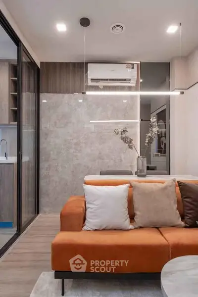 Modern living room with stylish orange sofa and sleek air conditioning unit