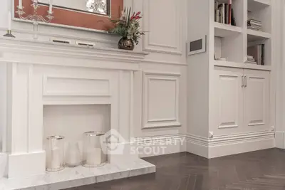 Elegant living room with classic white fireplace and built-in shelving