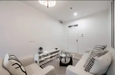 Modern minimalist living room with white decor and cozy seating
