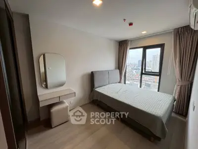 Modern bedroom with city view, featuring a stylish bed and vanity set, perfect for urban living.