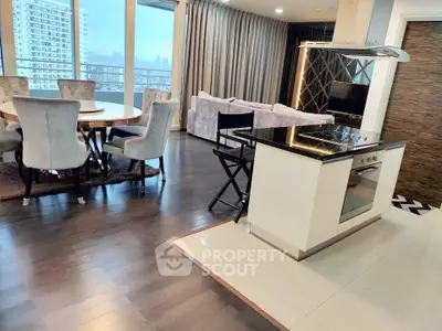 Luxurious open-plan living room with modern kitchen and stunning city view.