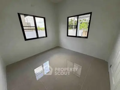 Bright empty room with large windows and glossy tiled floor, perfect for customization.