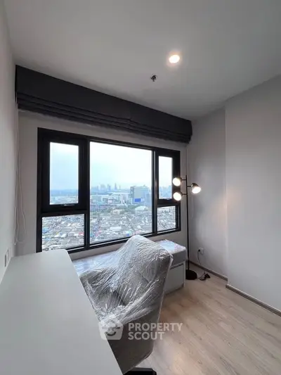 Modern study room with city view, featuring sleek desk and chair, ideal for productivity and relaxation.