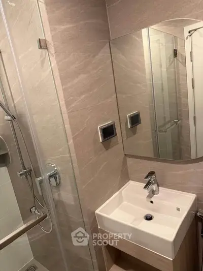 Modern bathroom with sleek fixtures and glass shower enclosure
