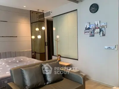 Modern bedroom with stylish decor and cozy seating area