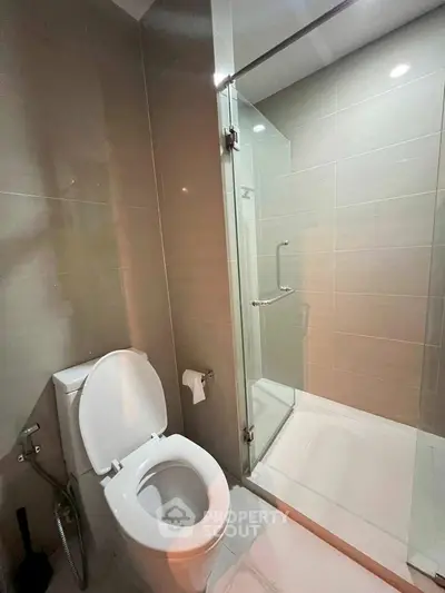 Modern bathroom with glass shower and sleek tile design