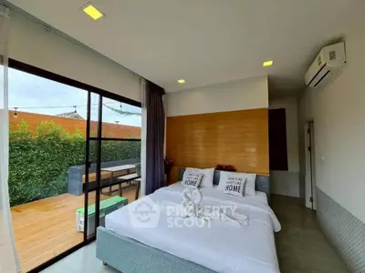 Modern bedroom with balcony access and stylish decor, perfect for relaxation.