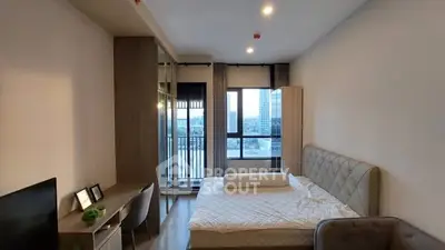 Modern bedroom with large window and stylish decor in urban apartment