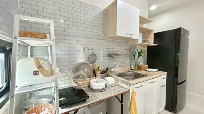Modern kitchen with sleek black fridge and stylish open shelving