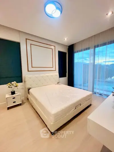 Luxurious bedroom with elegant decor and large windows offering stunning views.
