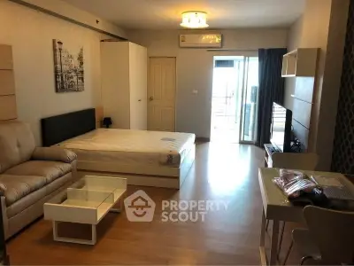 Spacious studio apartment with modern furnishings and balcony access