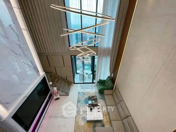 Luxurious high-ceiling living room with modern lighting and panoramic city view.