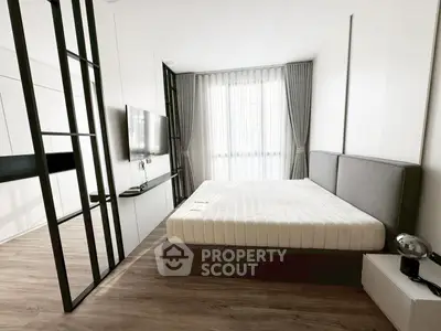 Modern bedroom with sleek design, featuring a large bed, wall-mounted TV, and elegant floor-to-ceiling curtains.