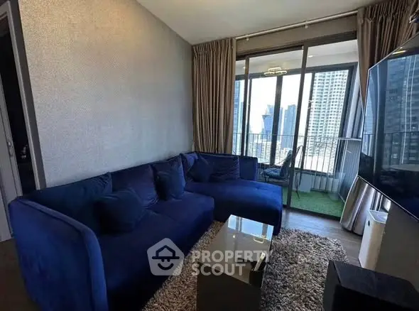 Modern living room with blue sofa and city view balcony in luxury apartment