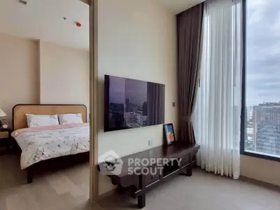 Modern bedroom with city view, featuring a wall-mounted TV and elegant decor.