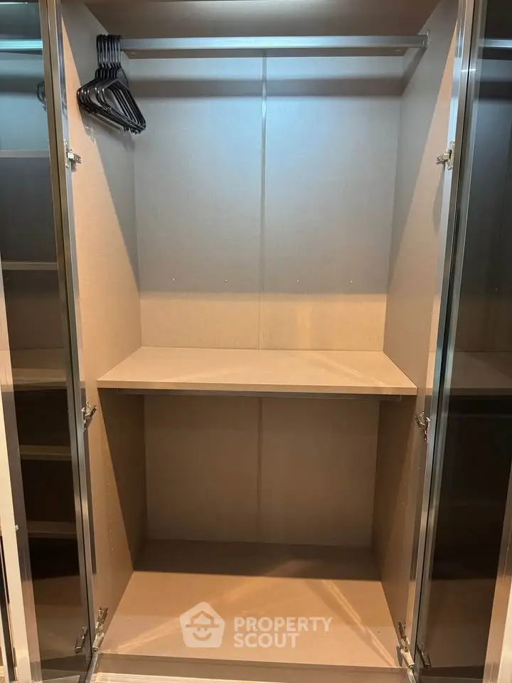 Spacious walk-in closet with ample shelving and hanging space in modern home.