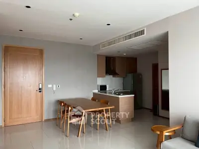 Modern open-layout kitchen and dining area with sleek wooden furniture